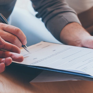 couple signing paperwork with advisor