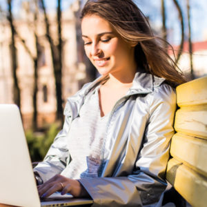 young woman on laptop in park