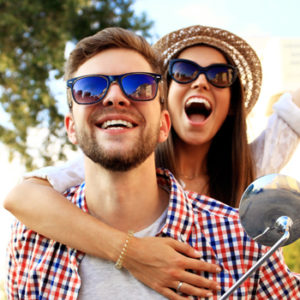 happy couple riding on scooter